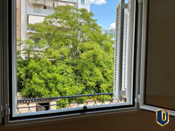 Ανοιχτό παράθυρο υπνοδωματίου με θέα σε πράσινο, σε διαμέρισμα στην Κυπριάδου – Άνω Πατήσια.