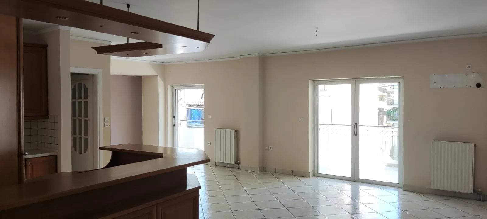 Σαλόνι με κουζίνα στον Άγιο Ελευθέριο | 150-1048 Ενιαίος χώρος σαλονιού και κουζίνας με ξύλινο πάσο και πρόσβαση στο μπαλκόνι, σε διαμέρισμα στον Άγιο Ελευθέριο Αθήνας.